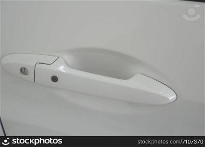 Modern white car door handle. Car door handle is an external part of the car.