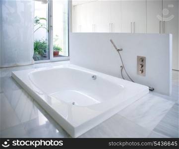Modern white house bathroom bathtub with marble floor and courtyard skylight