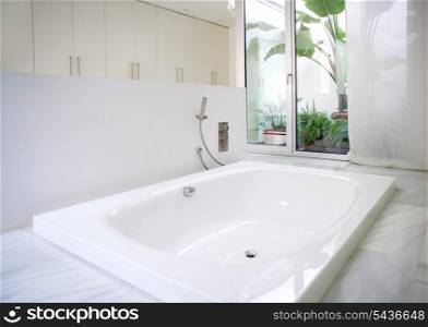 Modern white house bathroom bathtub with marble floor and courtyard skylight