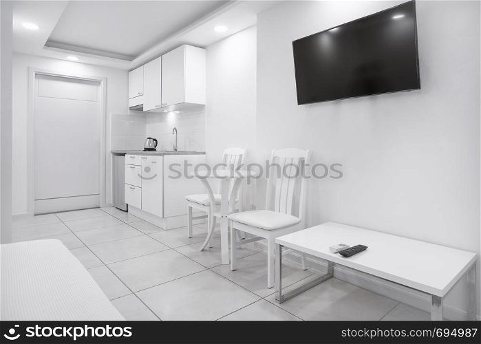Modern white room mock-up interior design with built-in kitchen furniture for a boutique hotel, apartment, residential showcase