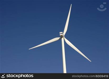 Modern white wind turbine or wind mill producing energy