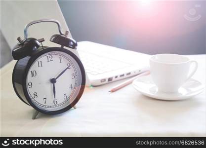 Modern white workspace and classic alarm clock with copy space