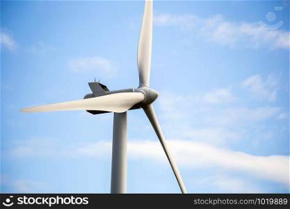 modern windmill on a sunny day and with idyllic white clouds, closeup of the foreground, Energy concept beauty. modern windmill on a sunny day and with idyllic white clouds, closeup of the foreground, Energy concept