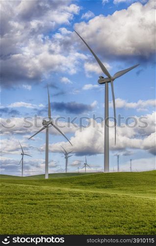 Modern windmills create clean enrgy using wind pwer on the wheat and grain farms in the Palouse area of Eastern Washington State in the USA.