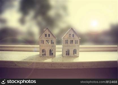 Modern window sill, closeup with two little white houses decoration retro design. Modern window sill, closeup with two little white houses decoration