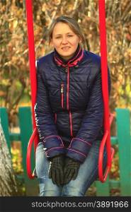 modern woman goes for a drive on the swing. modern woman goes for a drive on the swing in the autumn park