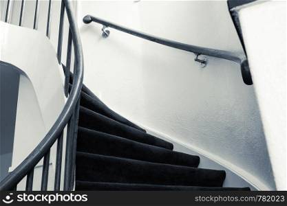Modern wooden spiral staircase with wooden steps in a new apartment in a residential building. luxury design close-up. Modern wooden spiral staircase with wooden steps in a new apartment in a residential building. luxury design black and white