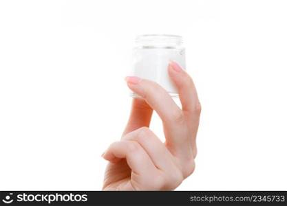 Moisturizing skin care, cosmetics, dermatology concept. Woman holding cream in little jar package, studio shot isolated. Woman holding cream in little jar package