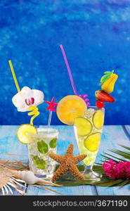 Mojito and lemon lime Cocktails in tropical Caribbean blue wood with starfish flowers and seashells