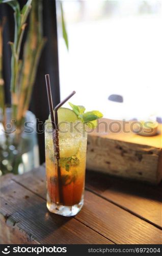 Mojito cocktail drink with mint and lemon background