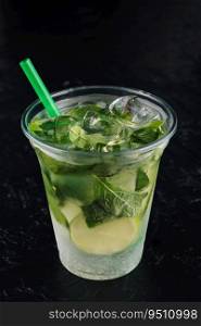 Mojito cocktail in a plastic glass with a tube