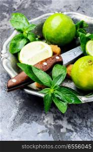 Mojito ingredients. Lime, mint and cane sugar. Fresh green mint and lime