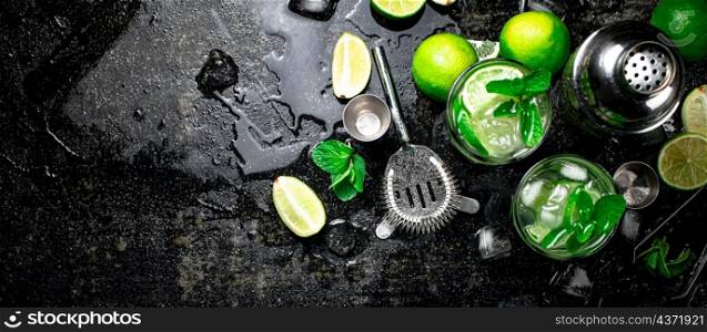 Mojito with mint and ice. On a black damp background. High quality photo. Mojito with mint and ice.