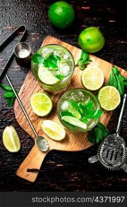 Mojito with mint castings. Against a dark background. High quality photo. Mojito with mint castings. Against a dark background.