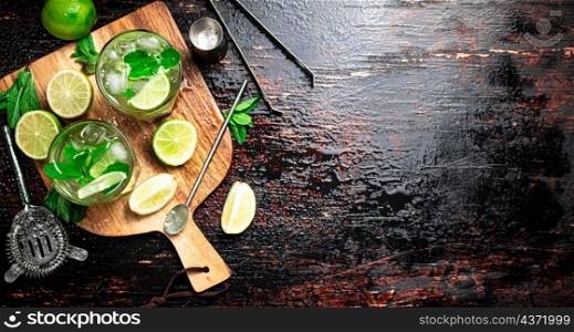 Mojito with mint castings. Against a dark background. High quality photo. Mojito with mint castings. Against a dark background.