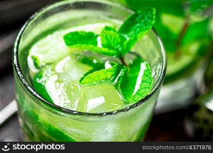 Mojito with mint leaves and ice. Macro background. High quality photo. Mojito with mint leaves and ice.