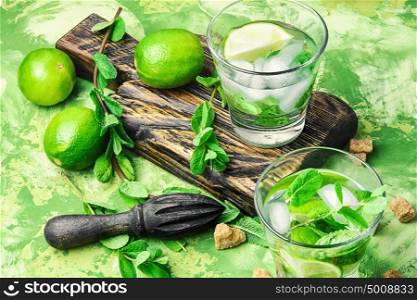 mojitos cocktail with lime and mint leaves