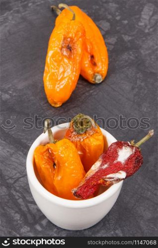 Moldy and wrinkled peppers. Concept of unhealthy, decompose, spoiled vegetable. Moldy and wrinkled peppers. Unhealthy, decompose, spoiled vegetable