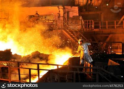 Molten hot steel pouring and worker