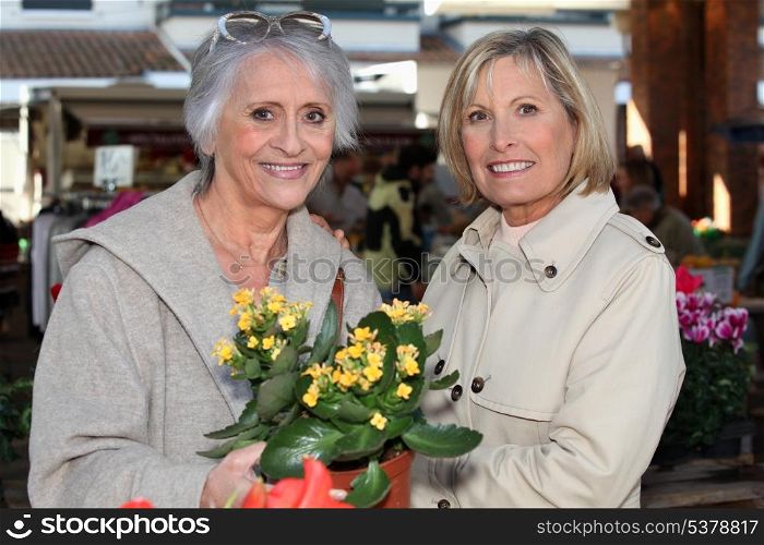 Mom and daughter buying flowers