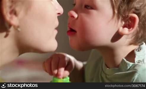 Mom and her son kissing. Lovely close ups.