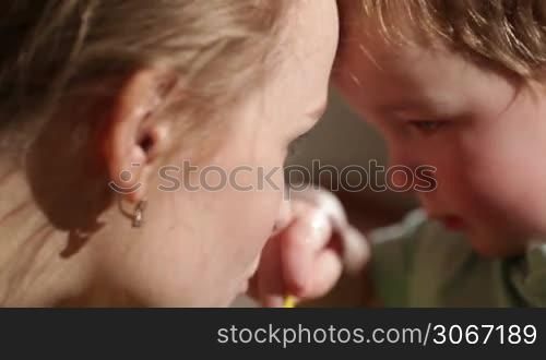Mom and her son kissing. Lovely close ups.