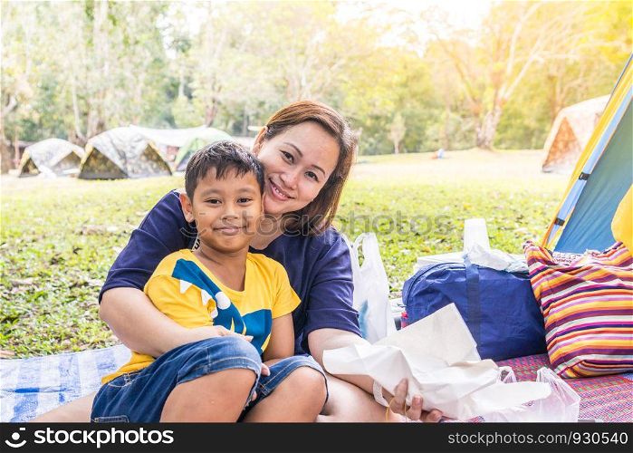 Mom and Son camping in forest.