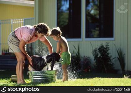 Mom and Son Washing Dog