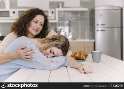 mom comforting tired daughter