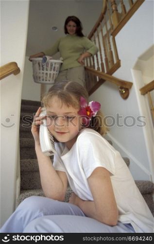 Mom Doing Laundry and Daughter Talking on the Phone