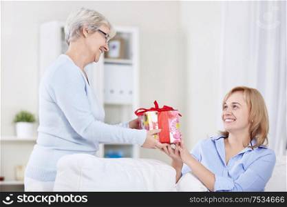 Mom hands her daughter a gift
