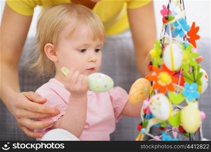 Mom helping baby made Easter decoration