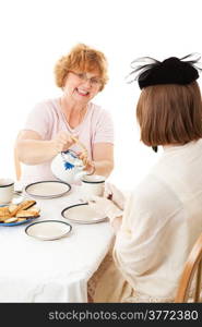 Mom pouring tea for her teenage daughter at a Mother&rsquo;s Day tea party. White background.