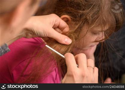 Mom tries to comb the girl&rsquo;s badly tangled hair
