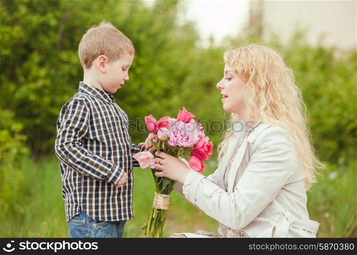 Mom with son and flowers for the Mothers day