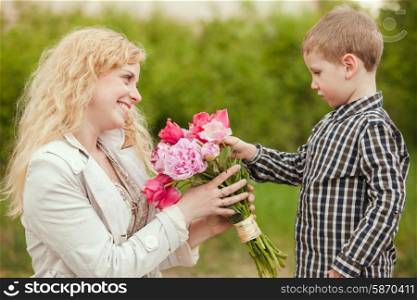 Mom with son and flowers for the Mothers day