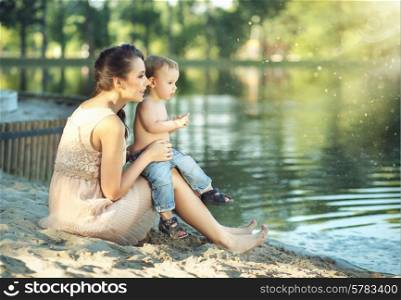 Mom with son looking at the calm lake