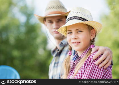 Moments of family togetherness. Father and daughter sitting on bridge and fishing