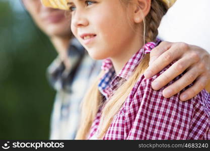 Moments of family togetherness. Father and daughter sitting on bridge and fishing