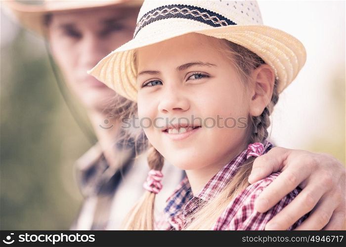 Moments of family togetherness. Father and daughter sitting on bridge and fishing