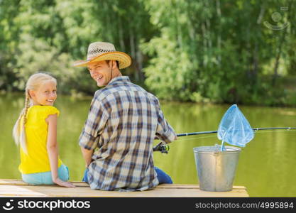 Moments of family togetherness. Rear view of father and daughter sitting on bridge and fishing