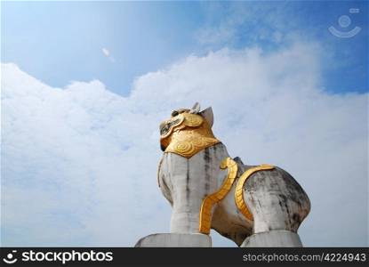 Mon Lion Statue in Sangkhlaburi on clear blue sky.