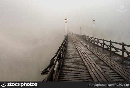 Mon wood bridge in the morning in the fog down (Sangkhla Buri, Kanchanaburi, Thailand) This Mon wood bridge is officially named Uthamanusorn Bridge. No focus, specifically.