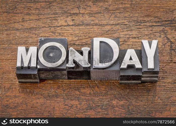 Monday word in mixed vintage metal type printing blocks over grunge wood