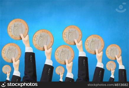 Monetary concept. Crowd of people holding five euro coin