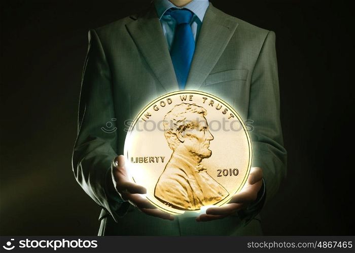 Monetary concept. Young businessman holding cent coin in palm