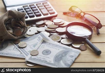 money and coin with business object on table