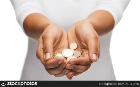 money and finances concept - close up of womans cupped hands showing euro coins. womans cupped hands showing euro coins