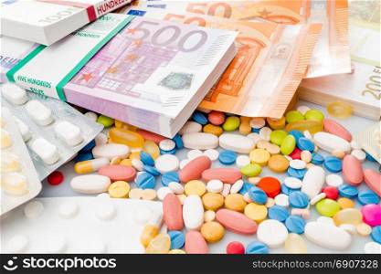 Money and pills. Pills of different colors on money. medicine concept. Euro cash