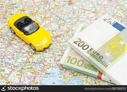 money and yellow car on map of Europe